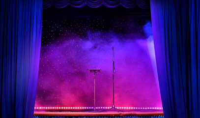 Elegant theatre show with colored spotlights and microphone