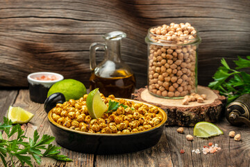 fried spicy chickpeas with lime on wooden table background. banner, menu, recipe place for text, top view
