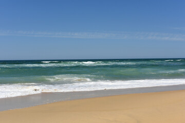 seaside with sandy beach and blue sky