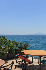 street pretty outdoor cafe with the beautiful view on the sea