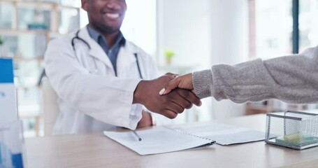 Hand, handshake and black man doctor greeting a patient for insurance policy in a hospital office. Medical, thank you and closeup of healthcare professional shaking hands in consulting for feedback