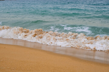 Fototapeta na wymiar waves on the sandy beach