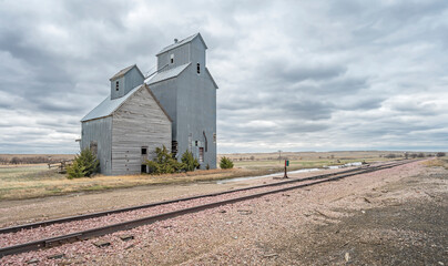 Abandoned grain elevator ruins beside the train tracks in the ghost town of Cottonwood, South...