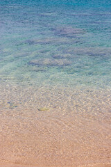 Clear water at the St Paul's bay beach creating a turquoise and brown gradient