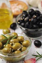 Black and green olives in glass bowls	