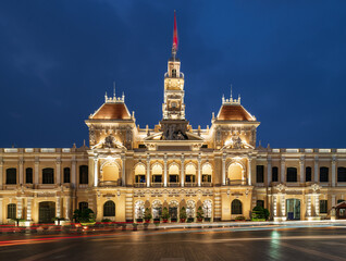 Fototapeta premium Traffic in front of Ho Chi Minh City Hall, Saigon City Hall or Committee Head office in the evening, Vietnam. Light trail and night. Popular place to visit in Saigon. Travel destinations in Vietnam
