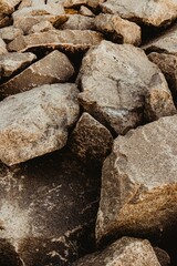 Vertical shot of massive rocks on the beach, perfect for wallpapers
