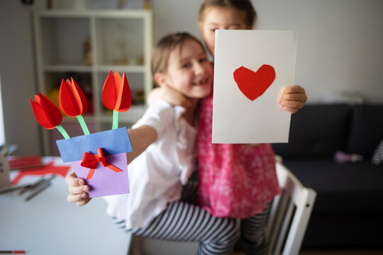 craft for kids. cards with heart and bouquet of paper flowers for mother's day, March 8 or birthday. DIY create art for children.