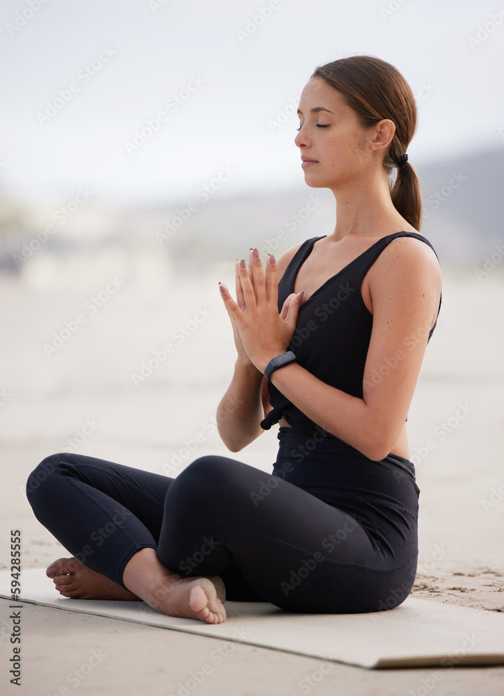 Poster Take this moment to focus on yourself. a young woman meditating while practising yoga at the beach.