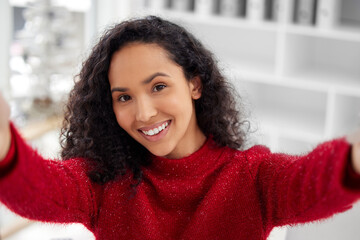 Quick Christmas selfie. a young woman taking a selfie while celebrating Christmas at home.