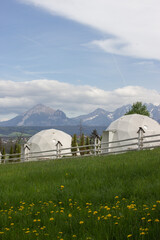 camping on a green field with beautiful view on the mountains