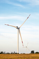 Wind energy. Wind power. Sustainable, renewable energy. Wind turbines generate electricity. Windmill farm on mountain with sunset sky. Green technology. Renewable resource. Sustainable development.