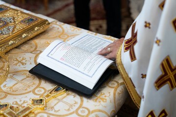 Closeup of the priest's hand on the book. Orthodox Church.