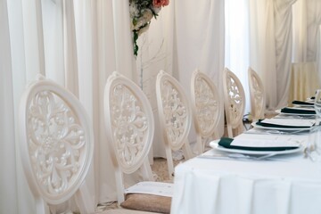 Empty chairs in the restaurant hall. Wedding ceremony.