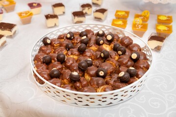 Closeup of colorful pastries  and chocolate candies at a wedding ceremony.