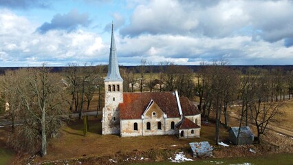 Fototapeta na wymiar Lutheran church on the outskirts of the Latvian village of Kabile in early April 2023