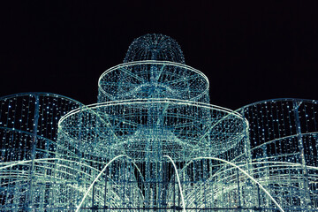 Illuminated fountain decorated with Christmas lights