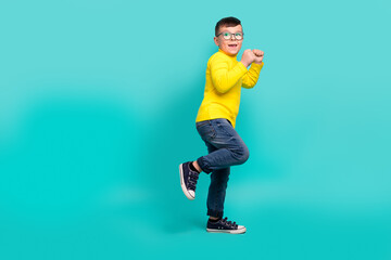 Full size photo of positive cheerful boy with fists up dancing energetic on school discotheque...
