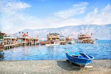 Fototapeta na wymiar Pleasure boats for tourists at the Chamlik pier on the way to the island of Cleopatra, Aegean Sea, Marmaris, Turkey