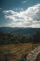 Vertical shot of mountains with greenery in a rural area on a sunny day