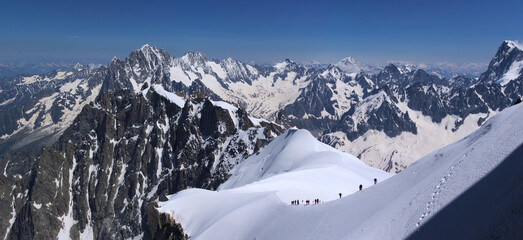 group of mountaineers climbing up on snow slopes, Mont Blanc massive, French Alps  - 594297164