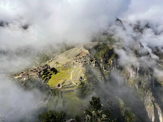 Landscape of the stunning mountains of Machu Picchu covered in the fog in Peru