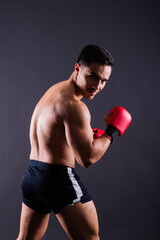 Fototapeta na wymiar Boxing gloves, man training in sports fight, challenge or mma competition on studio background.