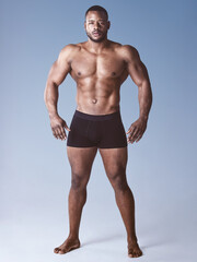 The personification of strength. Full length shot of a handsome young man posing shirtless in the studio.