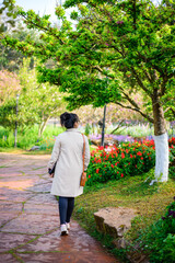 Female tourists walk to admire the beauty of flowers at Doi Ang Khang National Park.