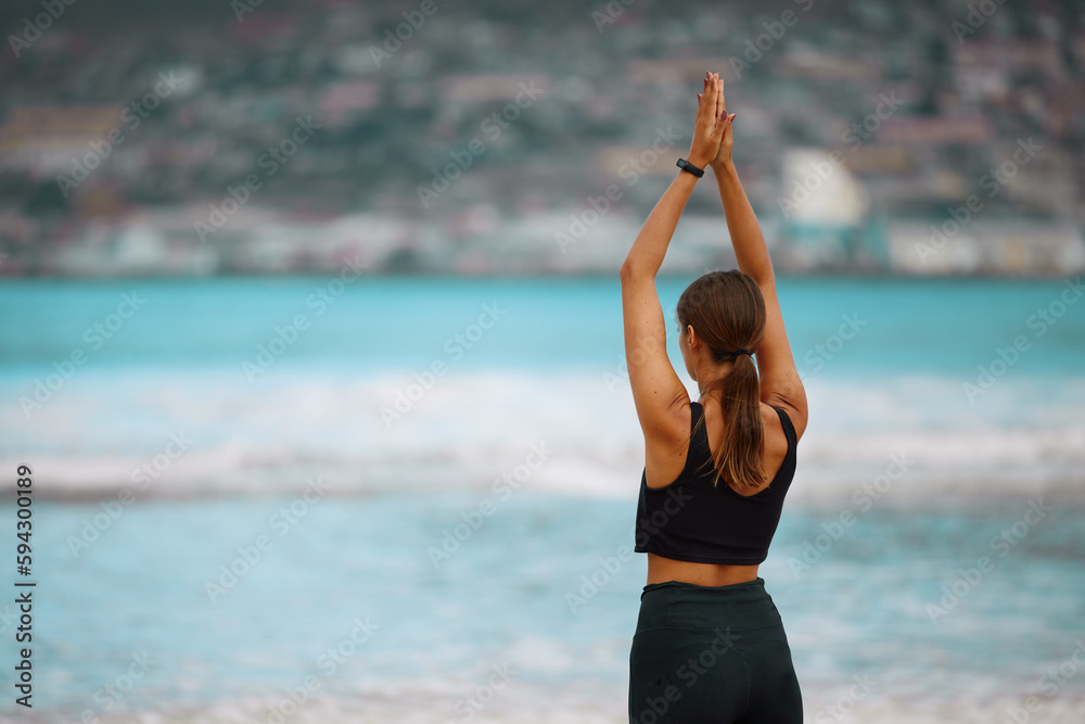 Poster Make the time to take care of your soul. Rearview shot of a young woman meditating while practising yoga at the beach.