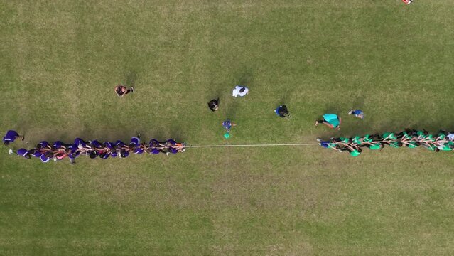 Aerial view of kids playing tug of war, slow motion