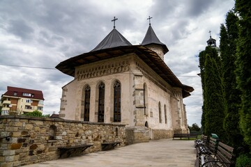 Fototapeta na wymiar Courtyard of Putna Monastery in Suceava County Romania, peaceful outdoor scene.