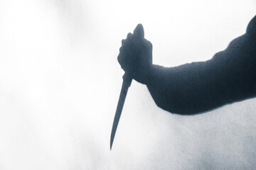 Shadow of  a murderer holding a knife - obrazy, fototapety, plakaty