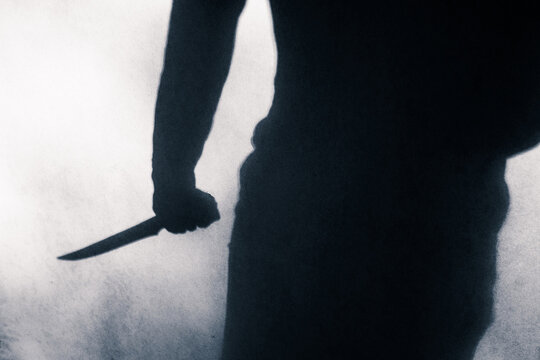 Shadow of person holding a knife