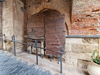 wooden medieval door of noli medieval village liguria italy
