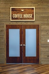 Frosted wooden doors with a sign above them. Coffee House.