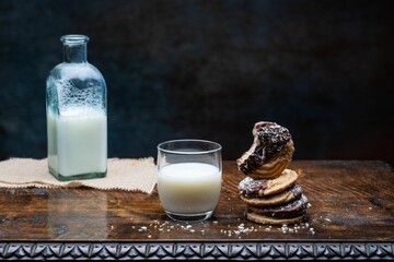 Closeup shot of a glass of milk and cookies on the table