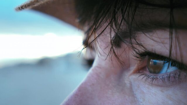 Ocean Gaze: Close-Up of Woman's Eyes Taking in the Beauty of the Sunset on the Sea