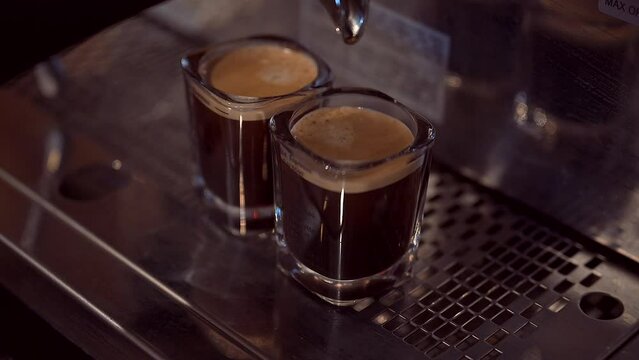 Slow motion closeup video of a process of making americano coffee