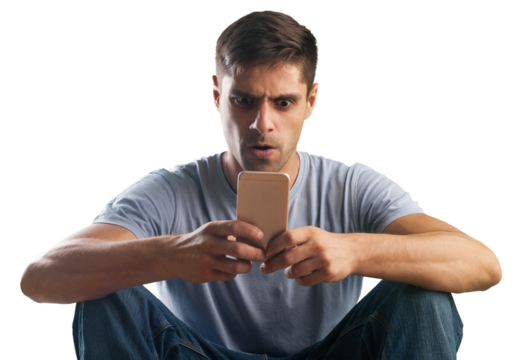 Shocked young man looking at his mobile phone seeing bad news or reading text message