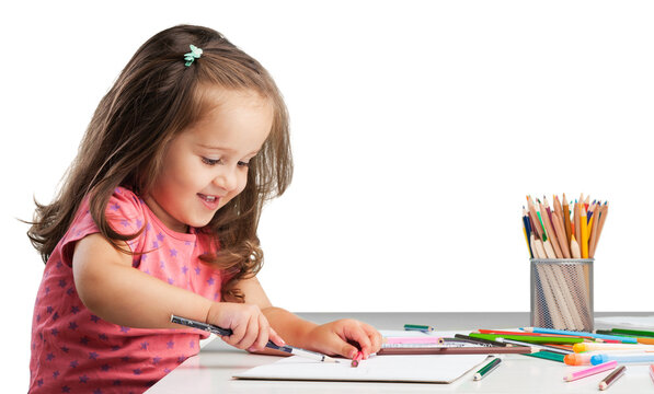 Cute little girl doing homework,writing and painting.