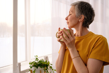 Inspired woman enjoying simple things after chemo at home