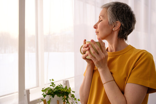 Inspired woman enjoying simple things after chemo at home