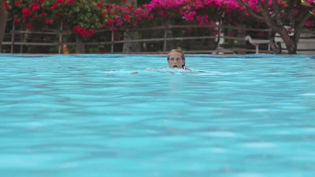 girl swims butterfly - a girl swims in a butterfly style pool slow motion shooting