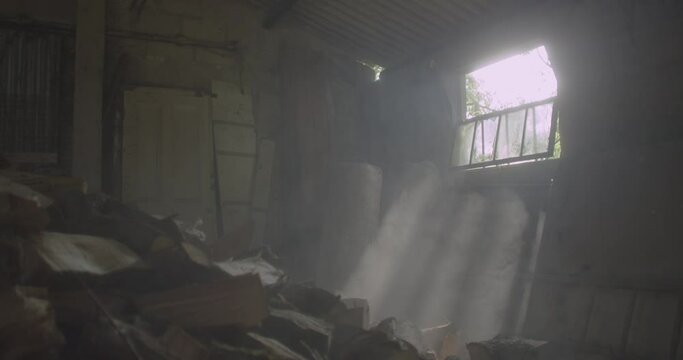 Sunbeams filling the empty, old barn in Devon, England