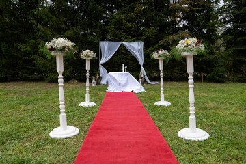 Alley with a red carpet for a wedding ceremony
