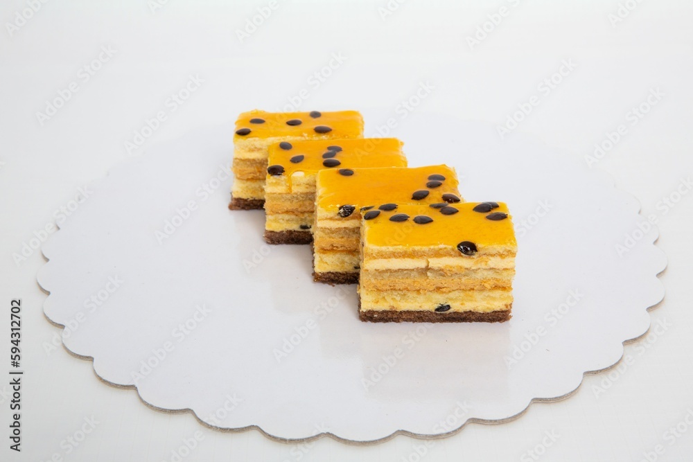 Wall mural slices of yellowish cakes on studio background