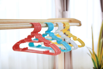 Colored plastic Clothes Hangers on wooden clothes line