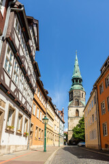 Hannover old city center street with protestant gothic style Church Holy Cross and ancient fachwerk building house. Lower Saxony traditional german acrhitecture urban cityscape european landmark