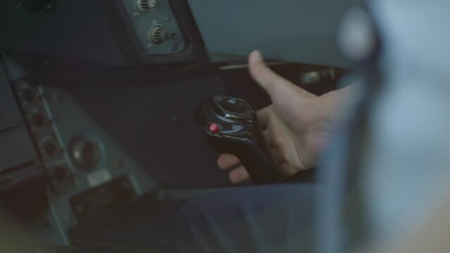 pilot making movements on the airplane's joystick